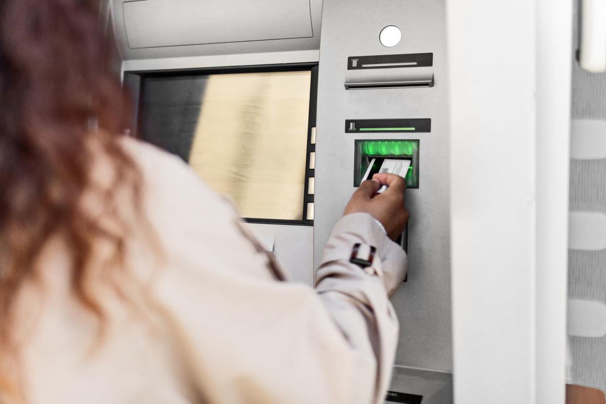 Young girl withdrawing money at ATM