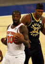 New York Knicks' Julius Randle (30) reacts after he was called for an offensive foul in the fourth quarter as Indiana Pacers' Myles Turner (33) looks on during an NBA basketball game Saturday, Feb. 27, 2021, in New York. (Elsa/Pool Photo via AP)