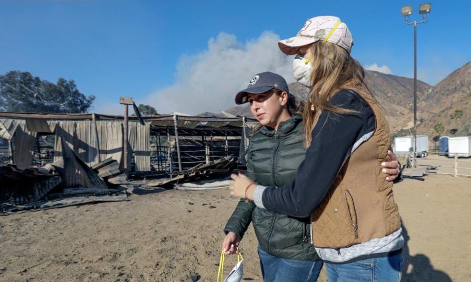 Virginia Padilla, left, who lost 29 horses at her Padilla Ranch on Little Tujunga Road is comforted by a horse trainer Shelby Hope.