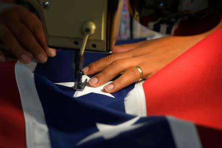 Blanca Hernandez sews stars on a Confederate Battle Flag in the Alabama Flag & Banner shop in Huntsville, Alabama, U.S., August 24, 2017. REUTERS/Harrison McClary