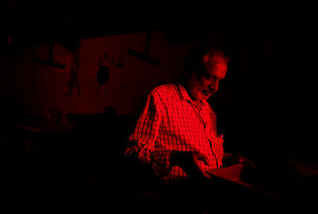 Devendran, a 55-year-old observer, works under red light inside a darkroom at the Kodaikanal Solar Observatory, India, February 5, 2017. REUTERS/Danish Siddiqui