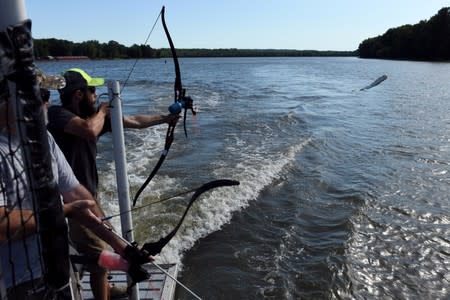 Captain Nate Wallick, of Peoria Carp Hunters, out on the Illinois River hunting the invasive species of fish, Asian carp