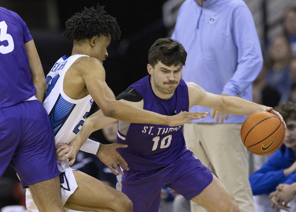 St. Thomas' Riley Miller, right, drives past Creighton's Trey Alexander during the first half of an NCAA college basketball game Monday, Nov. 7, 2022, in Omaha, Neb. (AP Photo/Rebecca S. Gratz)