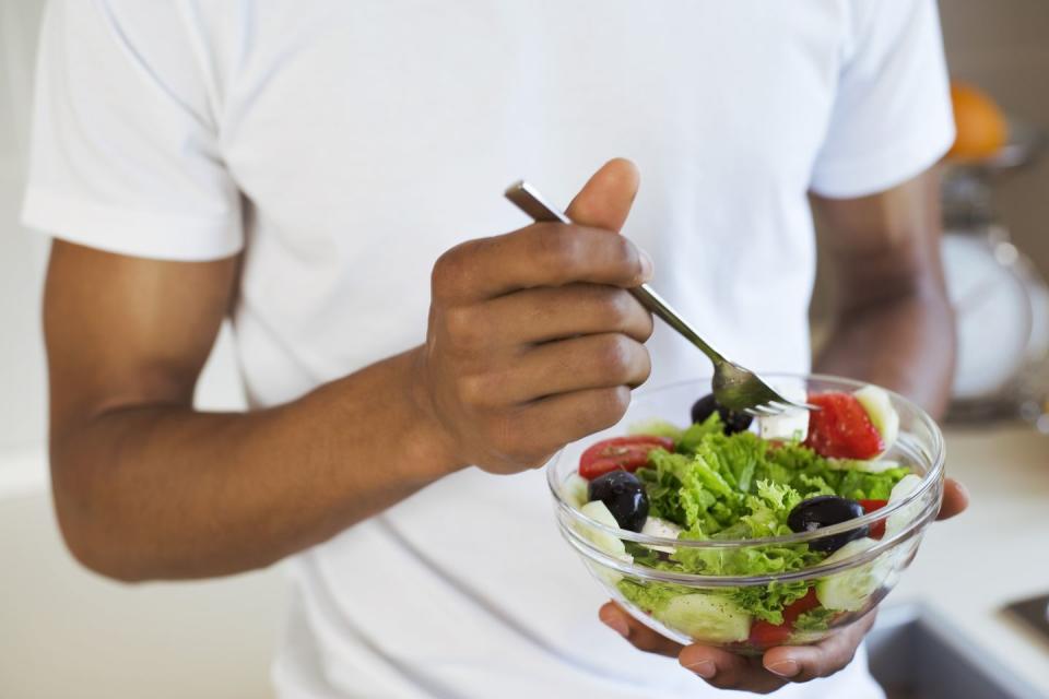 man eating salad