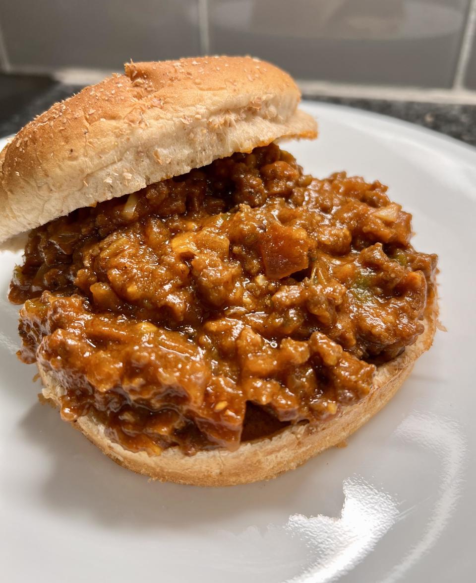 Close-up of a Sloppy Joe sandwich on a white plate