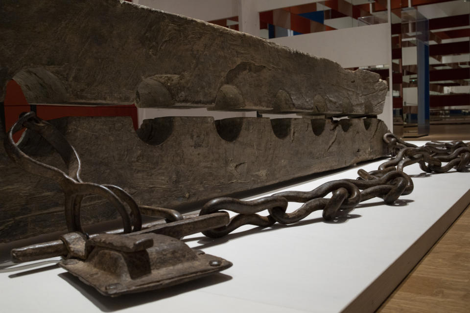 Tronco, or multiple foot stocks used to to constrain enslaved people, are seen at the Slavery exhibition Rijksmuseum in Amsterdam, Netherlands, Monday, May 17, 2021. The stark contrast between finery and brutality, wealth and inhumanity is a recurring pattern at the museum's unflinching new exhibition titled, simply, "Slavery", that examines the history of Dutch involvement in the international slave trade. (AP Photo/Peter Dejong)