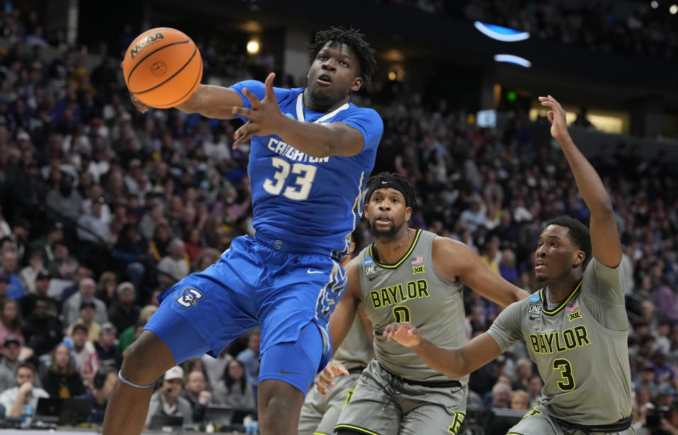 Creighton center Fredrick King, left, pulls in a rebound as Baylor forward Flo Thamba, center, and guard Dale Bonner defend during the second half of a second-round college basketball game in the men's NCAA Tournament on Sunday, March 19, 2023, in Denver. (AP Photo/David Zalubowski)