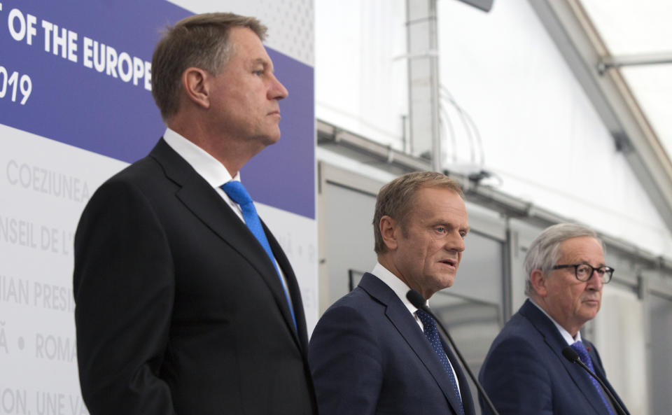 European Council President Donald Tusk, center, Romanian President Klaus Werner Ioannis, left, and European Commission President Jean-Claude Juncker participate in a media conference at an EU summit in Sibiu, Romania, Thursday, May 9, 2019. The European Union will be holding an extra summit two days after the May 26 European elections to assess who should get three top jobs that will be vacated in the fall. (AP Photo/Virginia Mayo)