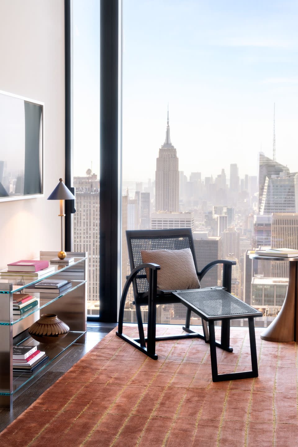 a room with a table and chairs and a window with a city skyline