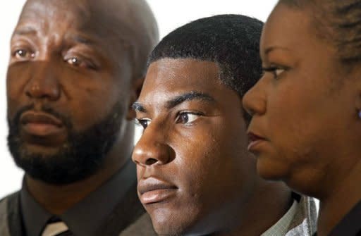 Tracy Martin (L), Jahvaris Fulton (C) and Sybrina Fulton (R), family of slain Trayvon Martin, listen to questions from the media during a press conference where they called for justice and the arrest of George Zimmerman, inside the Washington, DC, Convention Center. The neighborhood watch guard who shot dead an unarmed black teen in Florida has been charged with second degree murder