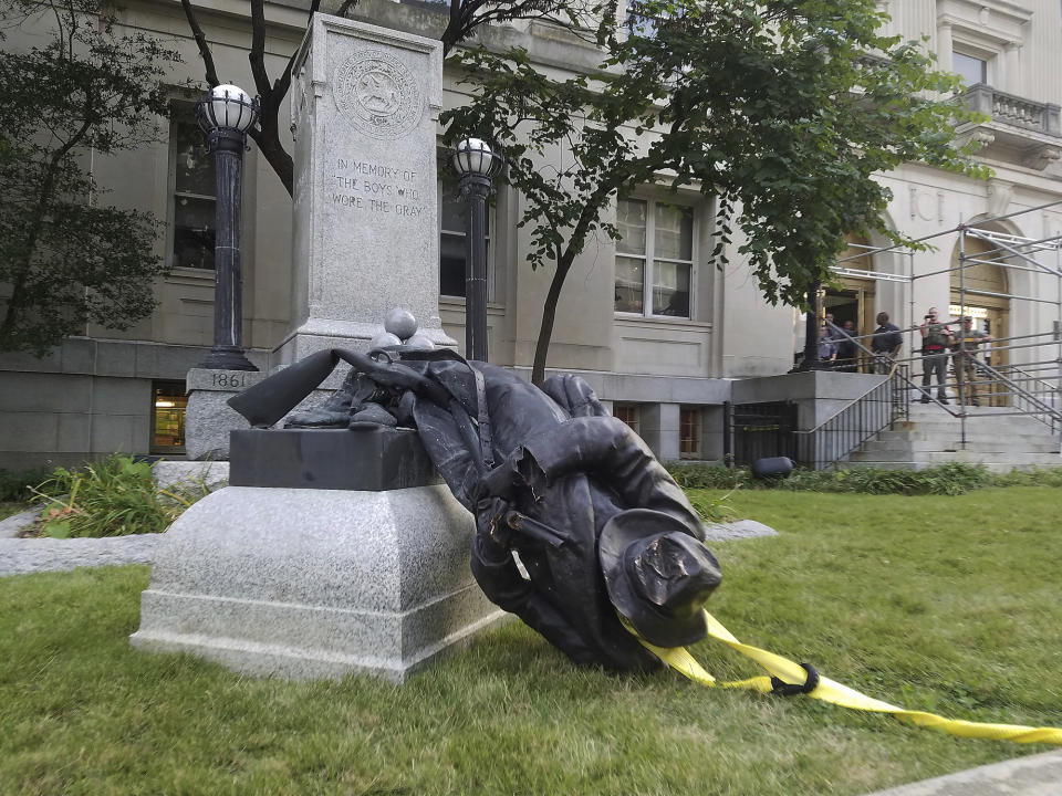 <p>A toppled Confederate statue lies on the ground on Monday, Aug. 14, 2017, in Durham, N.C. (Photo: Casey Toth/The Herald-Sun via AP) </p>