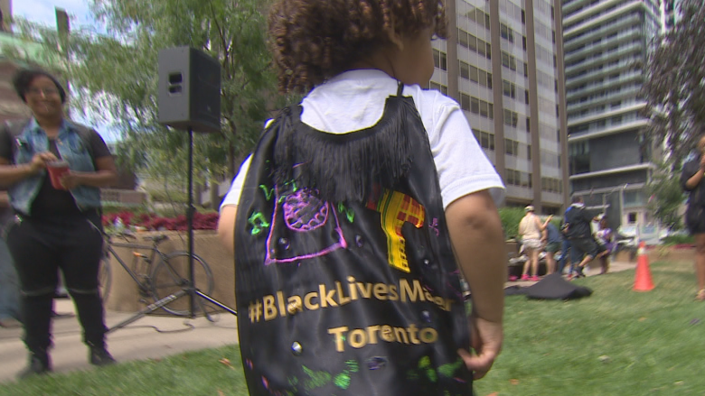 Children in superhero capes protest with Black Lives Matter outside U.S. Consulate