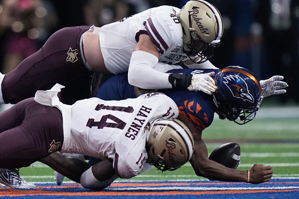 UTSA quarterback Frank Harris, center, is sacked by Texas State safety Justin Strong (40) and linebacker Kenny Haynes (14) during the first half of an NCAA college football game, Saturday, Sept. 9, 2023, in San Antonio. (AP Photo/Eric Gay)