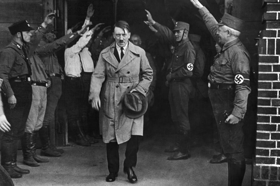 FILE - In this Dec. 5, 1931 file photo Adolf Hitler, leader of the National Socialists, leaves the party's Munich, Germany headquarters. On Friday, June 12, 2020, The Associated Press reported on stories circulating online incorrectly asserting that Hitler defunded the police and installed his own enforcers. Gavriel D. Rosenfeld, a historian and history professor at Fairfield University says, "Let’s just say the Nazis did everything BUT defund the police,” noting that Nazis made the police one of the chief recipients of state financial support aside from military spending. (AP Photo/File)