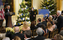 President Joe Biden looks at actor Steve Martin, standing right, a he speaks during the Kennedy Center Honorees Reception at the White House in Washington, Sunday, Dec. 5, 2021. The 2021 Kennedy Center honorees include Motown Records creator Berry Gordy, “Saturday Night Live” mastermind Lorne Michaels, actress-singer Bette Midler, opera singer Justino Diaz and folk music legend Joni Mitchell. (AP Photo/Carolyn Kaster)