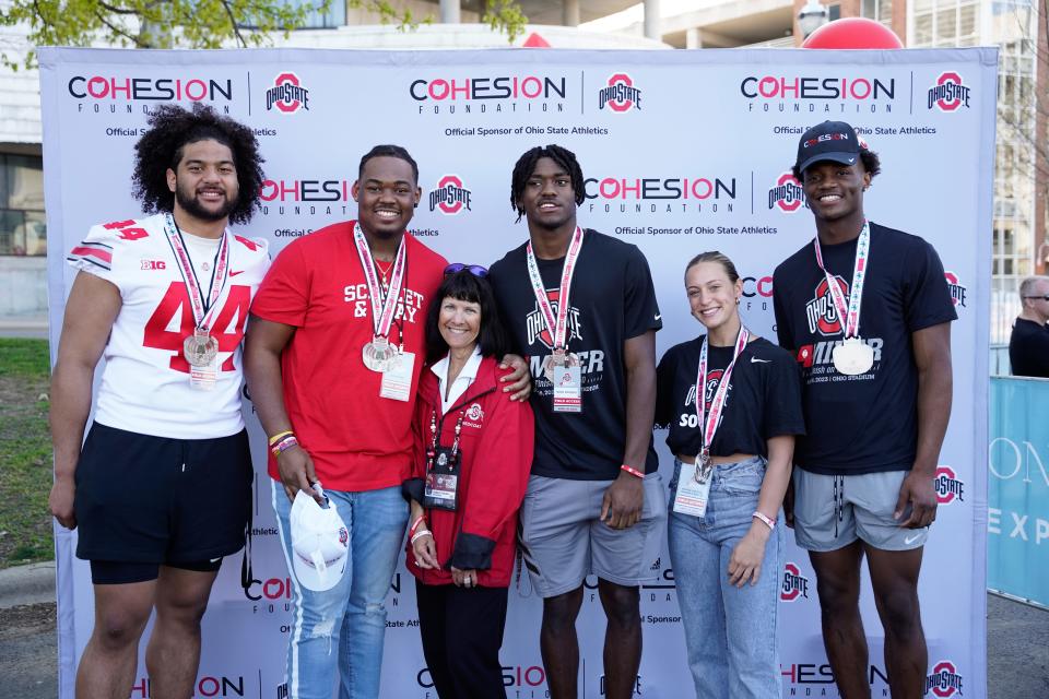 Ohio State football players (from left) : J.T. Tuimoloau, Vic Cutler, Noah Rogers and Carnell Tate at Ohio State's 4-Miler fundraiser.