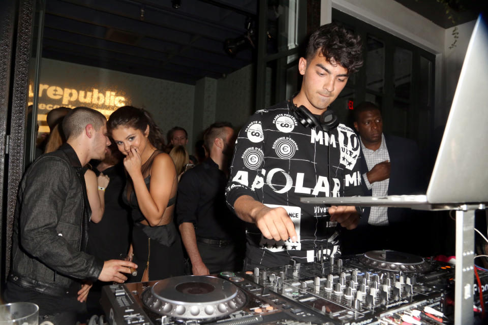 Nick Jonas and Selena Gomez in close conversation as Joe Jonas DJs at a Republic Records party in 2015<p>Rachel Murray/Getty Images for Republic Records</p>