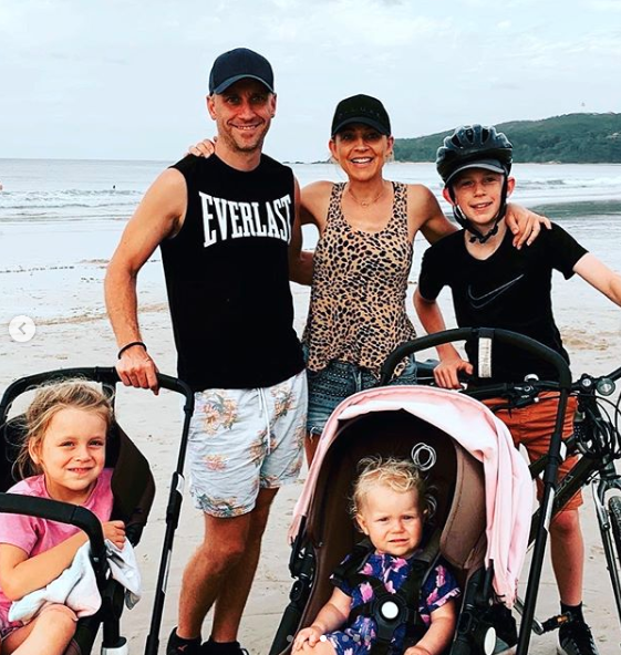 Carrie Bickmore and her family on the beach posing for the camera