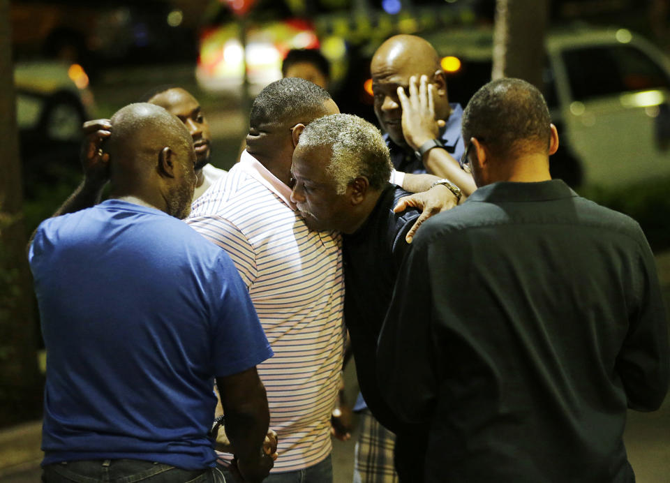 Worshippers embrace following a group prayer across the street from the Emanuel AME Church. (AP Photo/David Goldman)