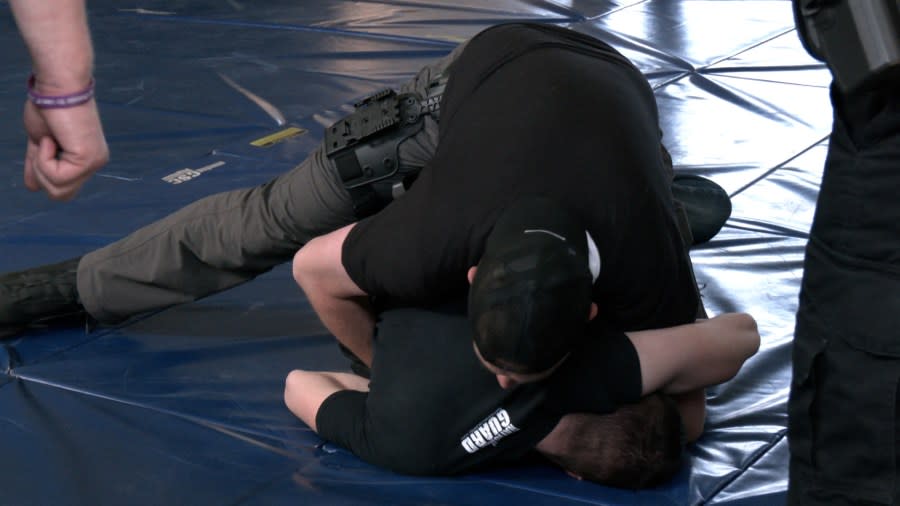 Officials from the Genesee County Sheriff’s department train on techniques to retain their weapons during struggles with suspects. (WLNS)