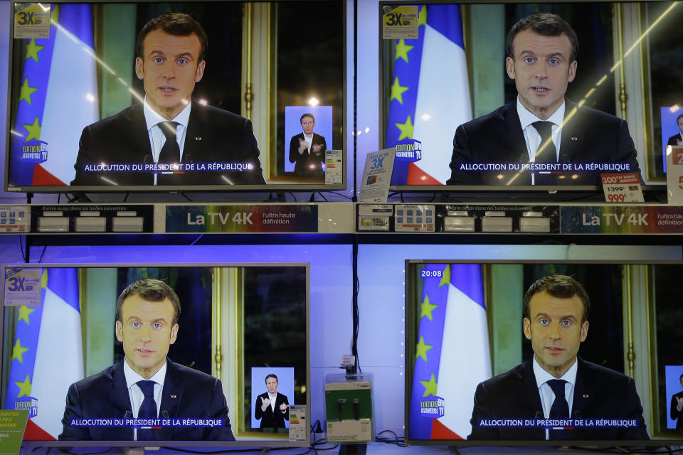 TV screens show French President Emmanuel during a televised address to the nation, at an electrical appliance store in Marseille, southern France, Monday, Dec. 10, 2018. President Emmanuel Macron has acknowledged he's partially responsible for the anger that has fueled weeks of protests in France, an unusual admission for the leader elected last year. (AP Photo/Claude Paris)