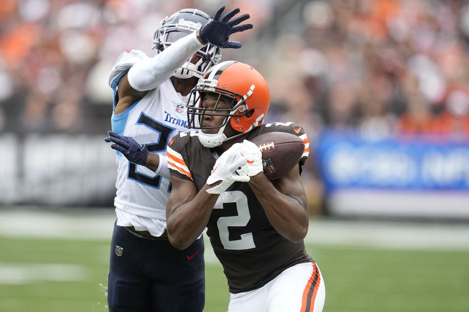 Cleveland Browns wide receiver Amari Cooper (2) makes a catch past Tennessee Titans cornerback Kristian Fulton during the first half of an NFL football game Sunday, Sept. 24, 2023, in Cleveland. The play was called incomplete as Cooper was ruled out of bounds. (AP Photo/Sue Ogrocki)