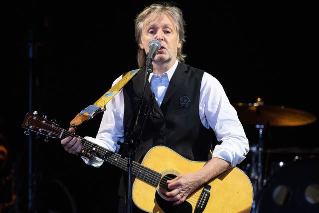 <p>Harry Durrant/Getty </p> Paul McCartney performing in Glastonbury in June 2022