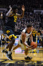 Purdue forward Mason Gillis (0) falls after being fouled by Iowa forward Josh Ogundele (23) during the first half of an NCAA college basketball game in West Lafayette, Ind., Friday, Dec. 3, 2021. (AP Photo/Michael Conroy)