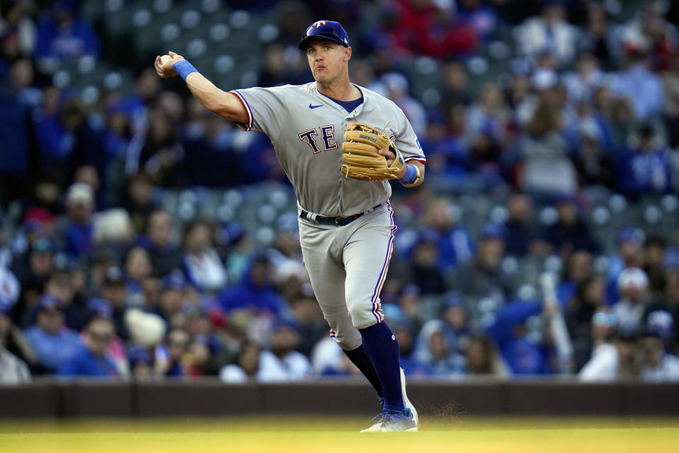 Texas Rangers third baseman Josh Jung throws to first to tag out Chicago Cubs third baseman Nick Madrigal during the seventh inning of a baseball game Saturday, April 8, 2023, in Chicago. (AP Photo/Erin Hooley)