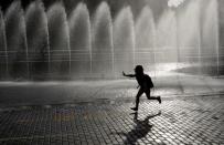 A child runs past a fountain in Yekaterinburg, Russia June 28, 2018. REUTERS/Darren Staples