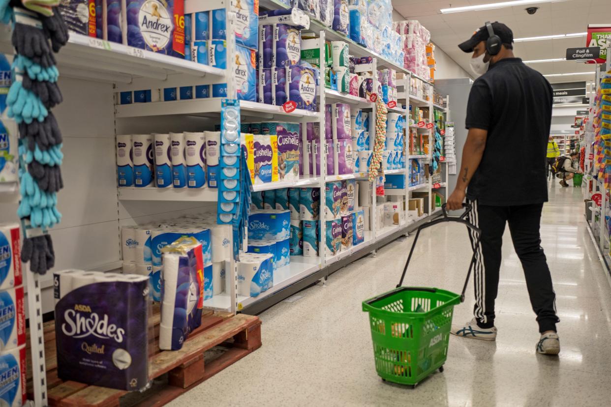 A man walks past the toilet paper in an Asda supermarket in Walthamstow, east London in Walthamstow, east London on September 23, 2020. - Britain on Tuesday tightened restrictions to stem a surge of coronavirus cases, ordering pubs to close early and advising people to go back to working from home to prevent a second national lockdown. (Photo by Tolga AKMEN / AFP) (Photo by TOLGA AKMEN/AFP via Getty Images)