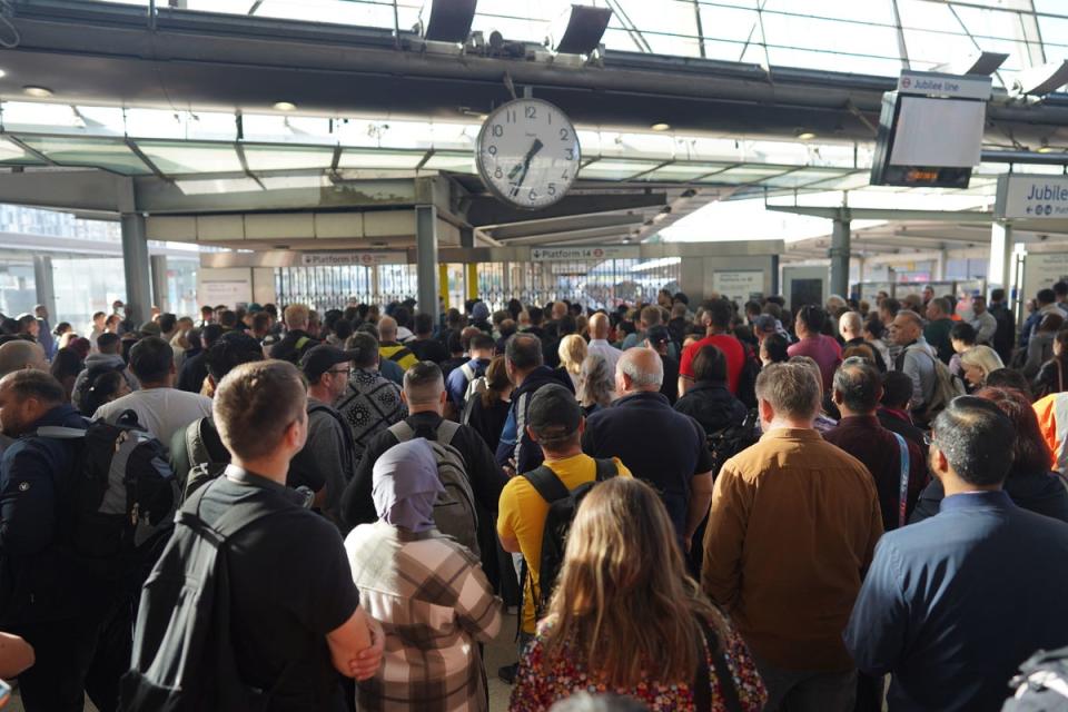 Passengers wait for Stratford station to open in London (PA)