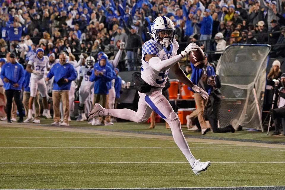 In this file photo, Kentucky defensive back Jalen Geiger scores a touchdown off an interception against Vanderbilt in the first half of a game Nov. 13, 2021, in Nashville, Tenn. Geiger is transferring after five seasons with the Wildcats.
