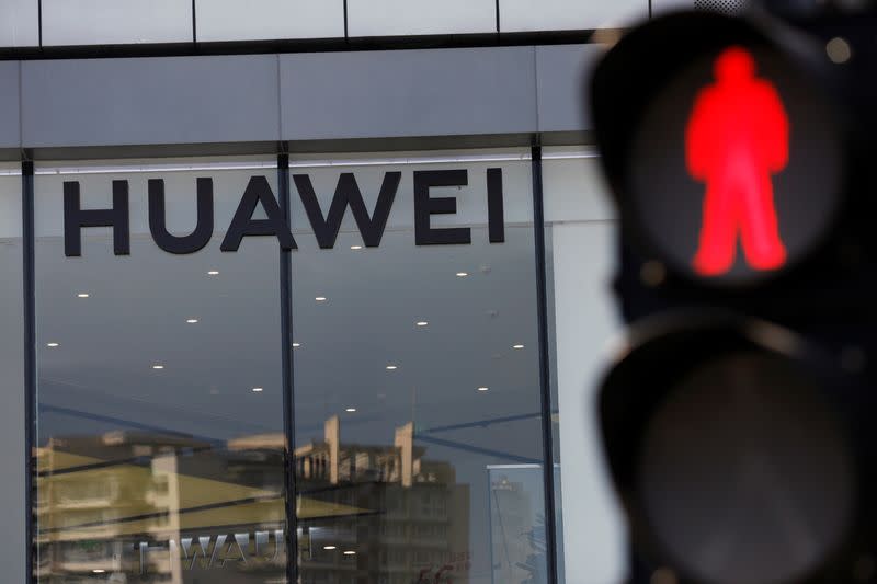 Huawei sign is seen on its store near a traffic light in Beijing