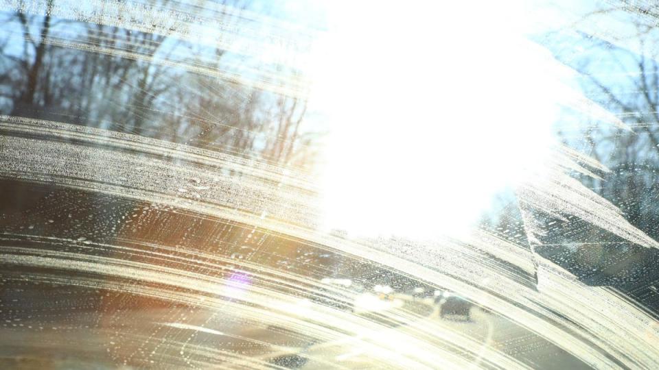 How to Clean Windows Without Streaks: Sun glare through the windshield of a moving vehicle