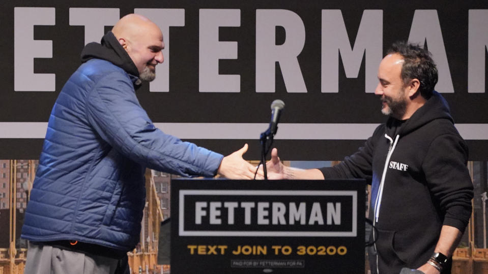 Pennsylvania Lt. Gov. John Fetterman, a Democratic candidate for U.S. Senate, left, introduces Dave Matthews who performed during a rally in downtown Pittsburgh, Wednesday, Oct. 26, 2022. (AP Photo/Gene J. Puskar)