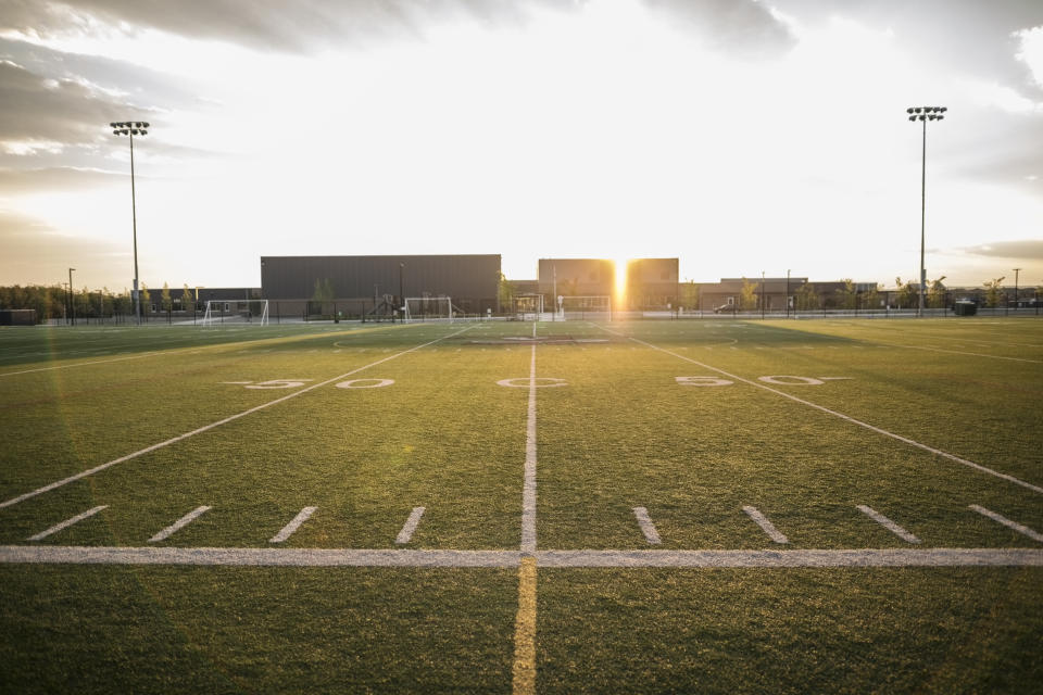 Sunny football field at sunset