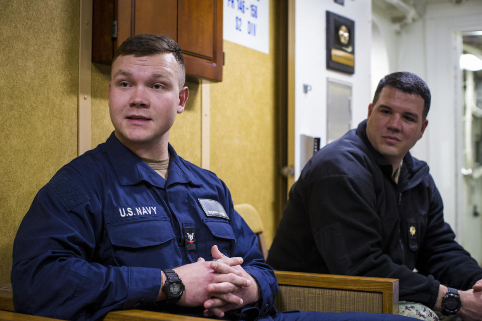 Petty Officer Third Class (PO3) Benjamin Dumas, left, alongside Navy Chaplain Lt. Cmdr. Nathan Rice speak about the "lay leader" aboard the USS Gravely on Tuesday, March 14, 2023 at Norfolk Naval Station in Norfolk, Va. Dumas is a prospective lay leader saying that he wants to serve his shipmates aboard the Gravely. “I’ve seen a lot of brokenness,” he says. (AP Photo/John C. Clark)