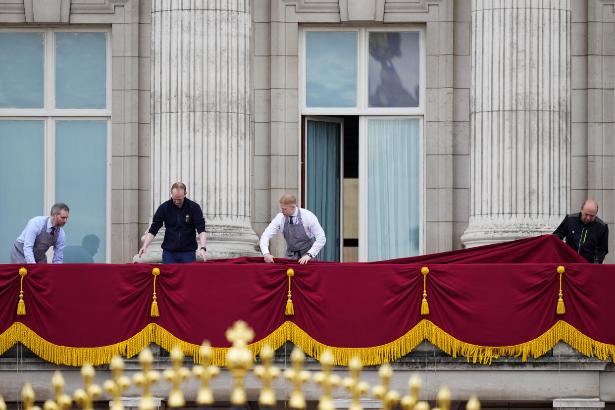 Workers prepare the balcony of Buckingham Palace ahead of Britain's King Charles III coronation ceremony in London, Saturday, May 6, 2023. (AP Photo/Petr David Josek)