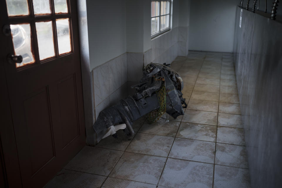 The engine found on the Mauritania boat that appeared drifting near Tobago lies in on a floor in the village of Belle Garden, Trinidad and Tobago, Wednesday, Jan. 19, 2022. (AP Photo/Felipe Dana)