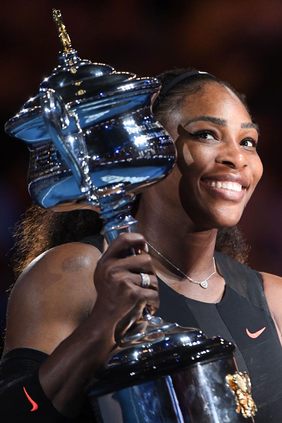 Serena Williams of the US celebrates with the championship trophy during the awards ceremony after her victory against Venus Williams of the US in the women's singles final on day 13 of the Australian Open tennis tournament in Melbourne on January 28, 2017. / AFP / WILLIAM WEST / IMAGE RESTRICTED TO EDITORIAL USE - STRICTLY NO COMMERCIAL USE        (Photo credit should read WILLIAM WEST/AFP/Getty Images)