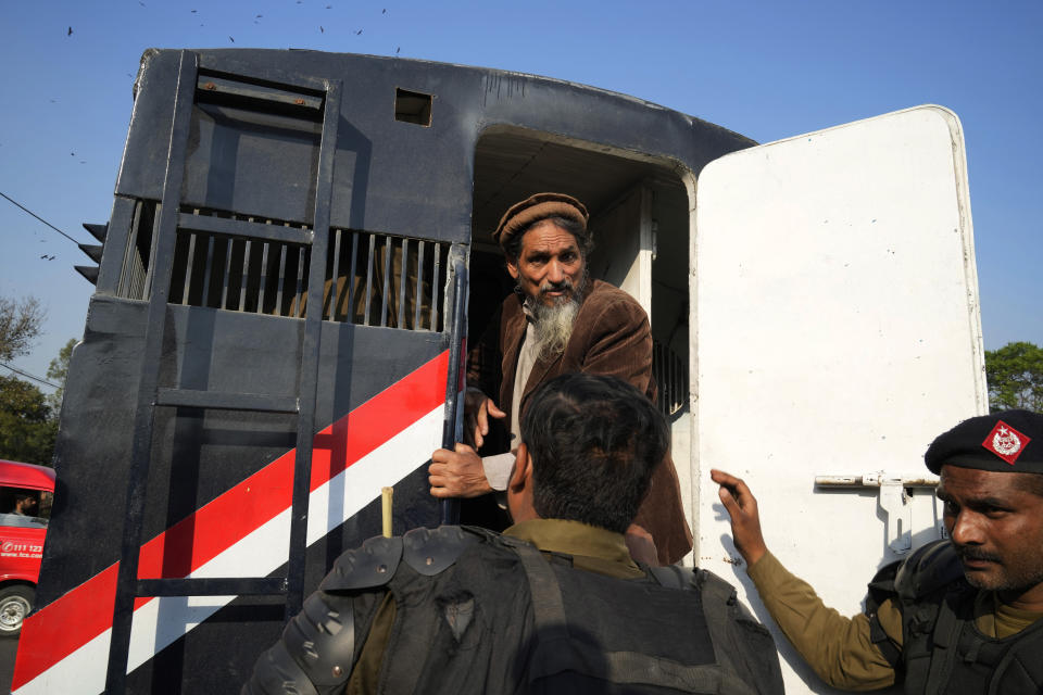 Police officers detain a supporter of Pakistan's former Prime Minister Imran Khan during a clash, in Lahore, Pakistan, Wednesday, March 8, 2023. Pakistani police used water cannons and fired tear gas to disperse supporters of the country's former Prime Minister Khan Wednesday in the eastern city of Lahore. Two dozen Khan supporters were arrested for defying a government ban on holding rallies, police said. (AP Photo/K.M. Chaudary)