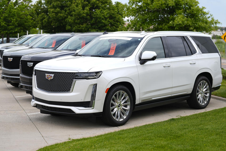 FILE - Unsold 2024 Escalade utility vehicles are parked at a Cadillac dealership on June 2, 2024, in Lone Tree, Colo. (AP Photo/David Zalubowski, File)