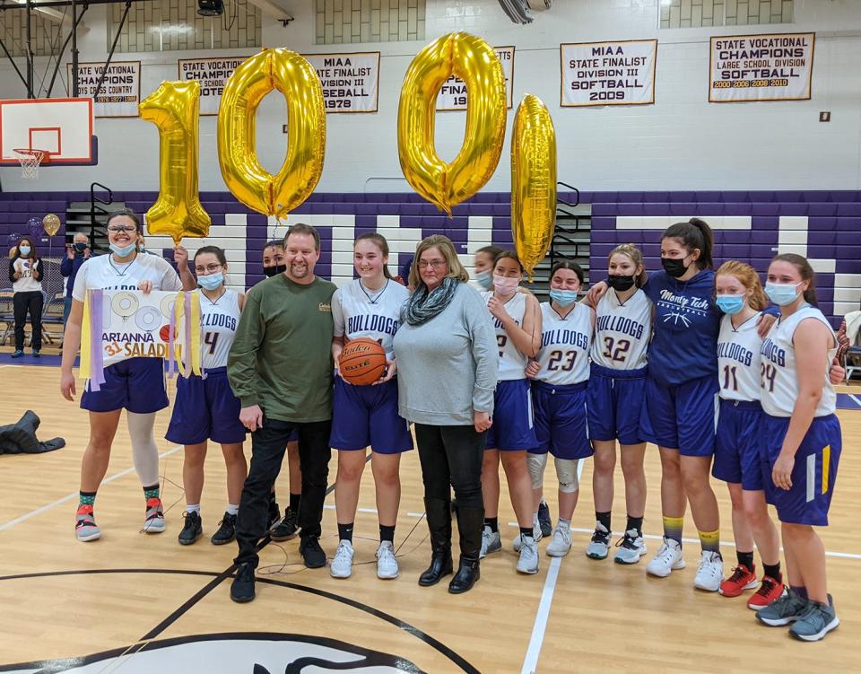 Monty Tech senior Ari Saladini celebrates scoring her 1,000th career point with her parents, Brian and Christine Saladini, and her teammates during Monday's game against Main South in Fitchburg.