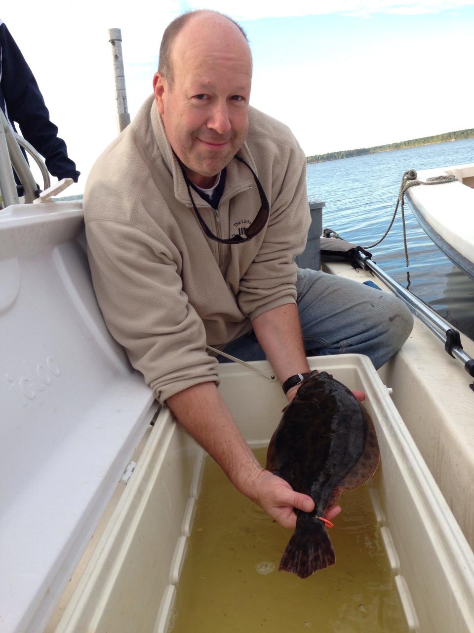 Dr. Fred Scharf from UNCW seen in 2013 with a tagged southern flounder to track the fish's movements.