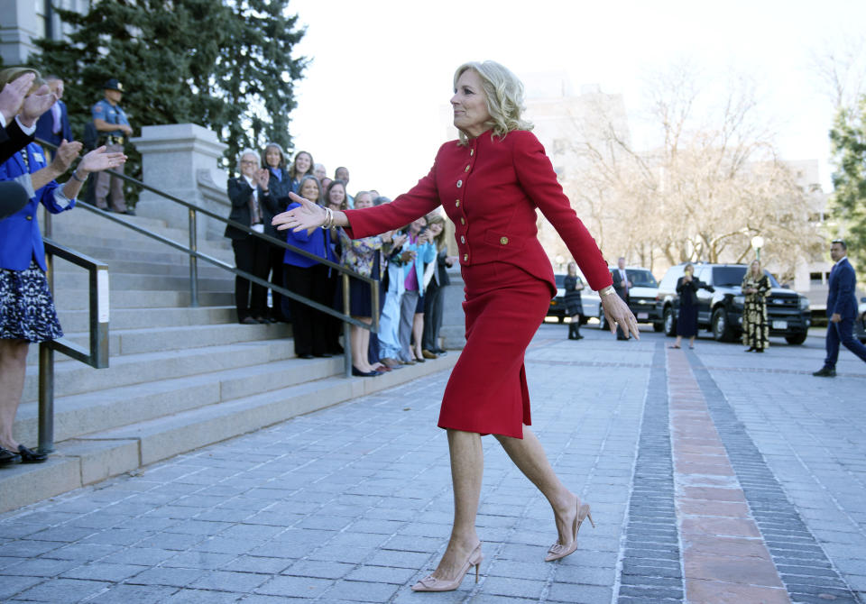 First lady Jill Biden greets lawmakers during a stop to attend a roundtable discussion on the federal workforce training program to help community college students earn certificates for entry-level jobs Monday, April 3, 2023, outside the State Capitol in Denver. Both Republican and Democratic state lawmakers were on hand for the first lady's visit, the first of four stops across the country to promote the Biden Administration's effort to invest in America. (AP Photo/David Zalubowski)
