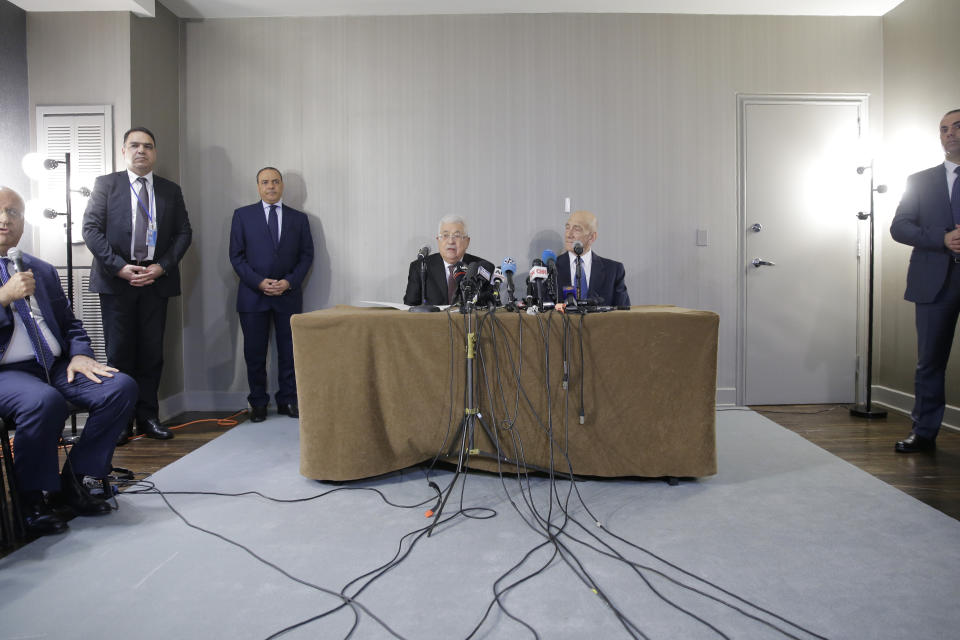 Palestinian President Mahmoud Abbas, center left, speaks while while former Israeli Prime Minister Ehud Olmert, center right, listens during a news conference in New York, Tuesday, Feb. 11, 2020. (AP Photo/Seth Wenig)