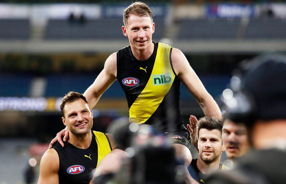 Dylan Grimes, pictured here being chaired off the ground by Richmond teammates after his 200th AFL game.