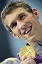 Michael Phelps of the U.S. smiles with his gold medal during the men's 4x100m medley relay victory ceremony at the London 2012 Olympic Games at the Aquatics Centre August 4, 2012. Phelps ended his incredible Olympic career on the perfect note on Saturday, winning his 18th gold medal for the United States in the men's medley relay, the last time he will swim a competitive race. He also received an award recognising him as the most decorated Olympian. REUTERS/Toby Melville (BRITAIN - Tags: OLYMPICS SPORT SWIMMING TPX IMAGES OF THE DAY) 