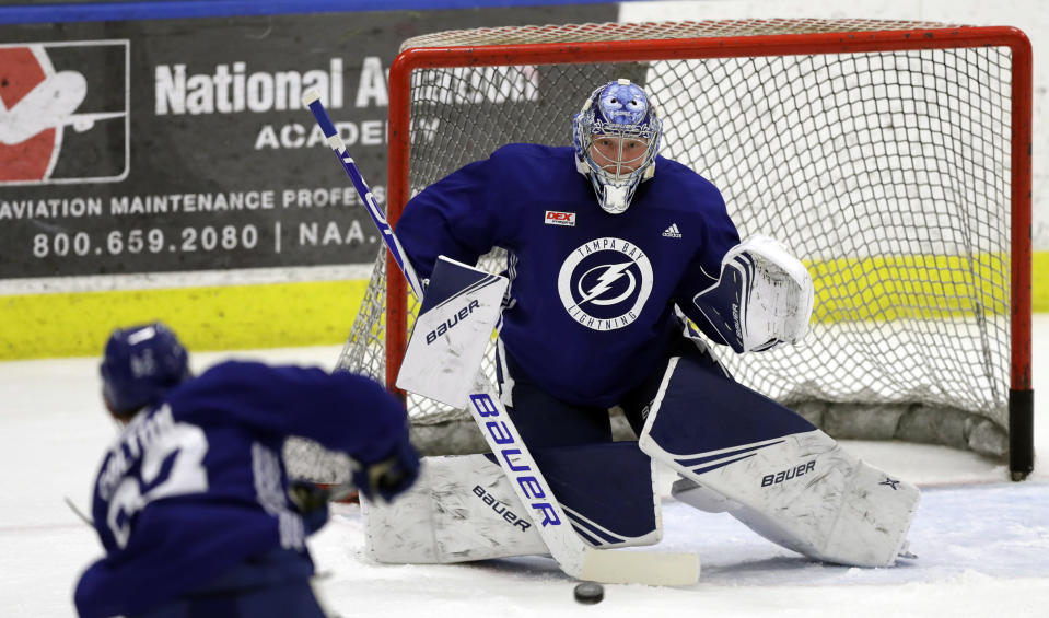 FILE - In this Sept. 13, 2019, file photo, Tampa Bay Lightning goaltender Andrei Vasilevskiy (88) eyes a shot during the first day of training camp, in Brandon, Fla. Fresh off finishing 21 points ahead of the NHL last regular season and going four and out in the playoffs, the Lightning are again Stanley Cup favorites and the team to beat in an ever-improving the Eastern Conference. (AP Photo/Chris O'Meara, File)